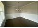 Dining room features hardwood floors, modern chandelier, and wainscoting at 5021 Falcon Pt, Douglasville, GA 30135