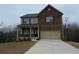 Charming two-story home with a brick front, a covered porch and an attached two-car garage at 5021 Falcon Pt, Douglasville, GA 30135