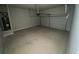 Empty two-car garage with concrete floor at 5021 Falcon Pt, Douglasville, GA 30135