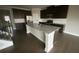 A kitchen showcases dark wood cabinets, stainless appliances, and a large granite island at 5021 Falcon Pt, Douglasville, GA 30135