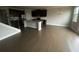 View of living room leading to kitchen with island and dark hardwood flooring at 5021 Falcon Pt, Douglasville, GA 30135