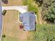 An aerial view of the home, showcasing its layout, roof, driveway, and surrounding landscape at 4265 Elmhurst Ln, Cumming, GA 30028