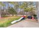 A large backyard with trees and a slide for the  at 4265 Elmhurst Ln, Cumming, GA 30028