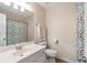 Bright bathroom featuring a vanity with sink, toilet, and shower with patterned curtain at 4265 Elmhurst Ln, Cumming, GA 30028