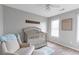 Cozy Bedroom with a comfortable chair and crib near a bright window at 4265 Elmhurst Ln, Cumming, GA 30028