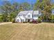 Charming two-story home featuring a well-manicured lawn and traditional architectural details at 4265 Elmhurst Ln, Cumming, GA 30028