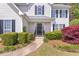 Charming front entrance with a black door, decorative wreath, and meticulously maintained landscaping at 4265 Elmhurst Ln, Cumming, GA 30028