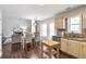 Bright kitchen seamlessly connected to the living area, featuring stainless appliances and wooden floors at 4265 Elmhurst Ln, Cumming, GA 30028