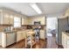 Charming kitchen featuring stainless steel appliances, granite countertops, and wooden flooring at 4265 Elmhurst Ln, Cumming, GA 30028
