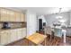 Open kitchen and dining area featuring granite counters, wooden floors and great natural light at 4265 Elmhurst Ln, Cumming, GA 30028