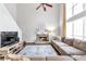 Inviting living room featuring a stone fireplace, large windows, and comfortable seating at 4265 Elmhurst Ln, Cumming, GA 30028