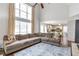 Spacious living room with a vaulted ceiling, large windows, and open access to the kitchen at 4265 Elmhurst Ln, Cumming, GA 30028