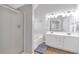 Well-lit main bathroom with double vanity, large mirror, and a separate bathtub and shower at 4265 Elmhurst Ln, Cumming, GA 30028