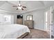 Spacious main bedroom featuring neutral colors, tray ceiling, and an en suite bathroom at 4265 Elmhurst Ln, Cumming, GA 30028