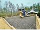 View of the community playground featuring slides, climbing structures, and ample space for children to play at 4265 Elmhurst Ln, Cumming, GA 30028