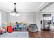Large playroom with ample space, featuring hardwood floors and modern chandelier at 4265 Elmhurst Ln, Cumming, GA 30028
