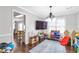 Spacious playroom with hardwood floors, bright lighting, and decorative crown molding at 4265 Elmhurst Ln, Cumming, GA 30028