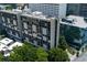 Aerial view of the building surrounded by lush trees and the city's modern architecture at 145 15Th Ne St # 1012, Atlanta, GA 30309