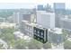 An aerial view featuring the building surrounded by the city's skyline and greenery at 145 15Th Ne St # 1012, Atlanta, GA 30309