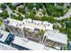 An aerial view of The Colony House, showcasing rooftop amenities, mature trees, and surrounding neighborhood at 145 15Th Ne St # 1012, Atlanta, GA 30309