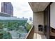 Balcony view of the city skyline surrounded by lush green trees at 145 15Th Ne St # 1012, Atlanta, GA 30309