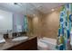 Bathroom with a dark vanity, large mirror, and a tub with a colorful shower curtain at 145 15Th Ne St # 1012, Atlanta, GA 30309