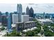 Elevated view of The Colony House condo building overlooking the city skyline with mature trees and foliage at 145 15Th Ne St # 1012, Atlanta, GA 30309