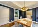 Elegant dining room showcases stylish decor, navy blue accent wall, and kitchen access at 145 15Th Ne St # 1012, Atlanta, GA 30309
