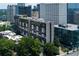 View of The Colony House residences, featuring a mid-rise building in a leafy neighborhood with views of the city skyline at 145 15Th Ne St # 1012, Atlanta, GA 30309