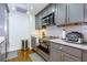 Well-lit kitchen boasts gray cabinetry, stainless appliances, and a white subway tile backsplash at 145 15Th Ne St # 1012, Atlanta, GA 30309