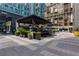 Outdoor dining area with shaded seating and lush greenery near the condos offers a relaxing experience at 145 15Th Ne St # 1012, Atlanta, GA 30309