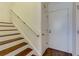 Wooden staircase complements a bright white interior; a classic design element for this home's entryway at 145 15Th Ne St # 1012, Atlanta, GA 30309