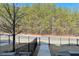 View from back porch, showing iron fence, trimmed lawn and wooded neighborhood at 353 Vista Ln, Woodstock, GA 30189