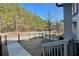 View from back porch, showing iron fence and wooded neighborhood beyond the street at 353 Vista Ln, Woodstock, GA 30189