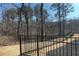 Fenced backyard with a grassy area and wooded view offers privacy and outdoor enjoyment at 353 Vista Ln, Woodstock, GA 30189