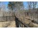 Fenced backyard with a grassy area and wooded view offers privacy and outdoor enjoyment at 353 Vista Ln, Woodstock, GA 30189