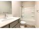 Well-lit bathroom featuring a single sink vanity, tile floors, and a shower-tub combination with white surround at 353 Vista Ln, Woodstock, GA 30189