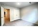 Bedroom featuring plush carpet, closet, neutral walls, and an open door leading to additional rooms at 353 Vista Ln, Woodstock, GA 30189