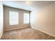 Neutral bedroom featuring plush carpet, two bright windows with blinds, and ample natural light at 353 Vista Ln, Woodstock, GA 30189