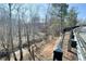 Scenic view of a tree-lined creek from along the roadside and the adjacent black fence at 353 Vista Ln, Woodstock, GA 30189