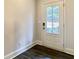 Exterior door featuring three glass panels, dark wood-look flooring, and neutral paint at 353 Vista Ln, Woodstock, GA 30189