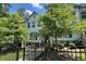 Charming two-story townhome showcasing a black fence, neat landscaping, and an inviting entrance at 353 Vista Ln, Woodstock, GA 30189