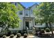 Beautiful two-story townhome featuring manicured landscaping and a secure black fence at 353 Vista Ln, Woodstock, GA 30189