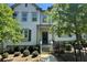 Inviting two-story townhome with manicured landscaping and a secure black fence at 353 Vista Ln, Woodstock, GA 30189