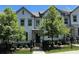 Charming two-story townhome featuring a black fence, neat landscaping, and an inviting entrance at 353 Vista Ln, Woodstock, GA 30189