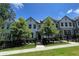 Charming townhome with manicured lawn and black metal fence that adds curb appeal at 353 Vista Ln, Woodstock, GA 30189