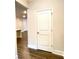 View of the foyer, featuring dark stained hardwood floors, trim, and a coat closet at 353 Vista Ln, Woodstock, GA 30189