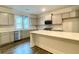 Bright kitchen features stainless steel appliances, light gray cabinetry and a large island at 353 Vista Ln, Woodstock, GA 30189