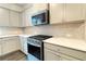 Modern kitchen with stainless steel appliances and light gray cabinetry at 353 Vista Ln, Woodstock, GA 30189