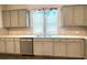 Close-up of kitchen with stainless steel dishwasher, sink, and white quartz countertops at 353 Vista Ln, Woodstock, GA 30189